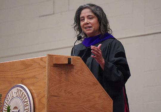 woman wearing gown at podium