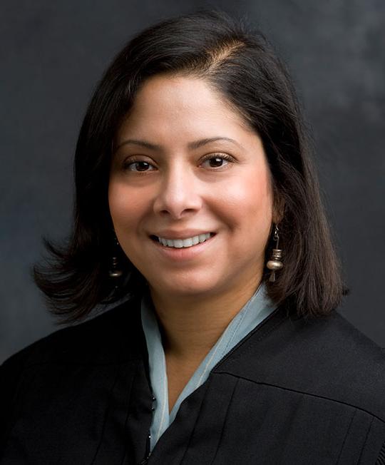 woman with dark hair wearing judge's robe