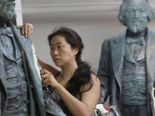 woman working on statues